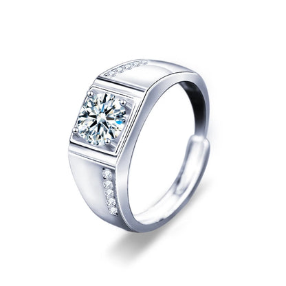 Silver ring with a large central gemstone and smaller stones on a white background